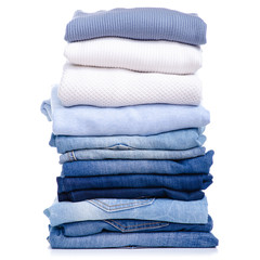 Stack blue jeans and clothes on white background isolation