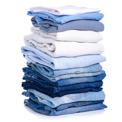 Stack blue jeans and clothes on white background isolation