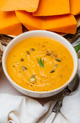 Delicious pumpkin cream. Home and rustic appearance. Includes fresh pumpkin, seeds and rye bread. Aerial view.