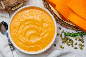 Delicious pumpkin cream. Home and rustic appearance. Includes fresh pumpkin, seeds and rye bread. Aerial view.