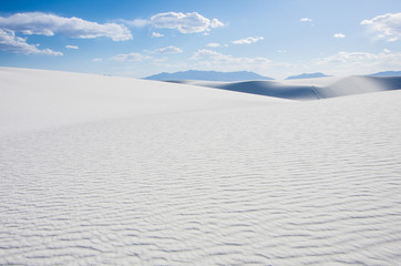 White sand dunes and blue cloudy sky in New Mexico desert