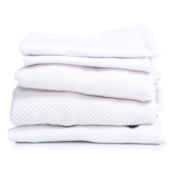 Stack white clothes t-shirt, sweater, jeans on white background isolation