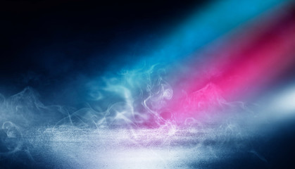 Dark empty stage, multicolored rays of neon searchlight, wet asphalt, smoke, night shooting, bokeh color.