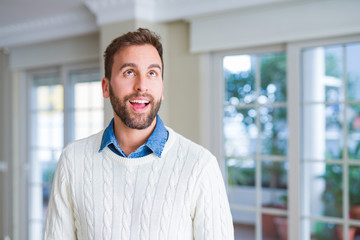 Handsome man smiling positive at the camera