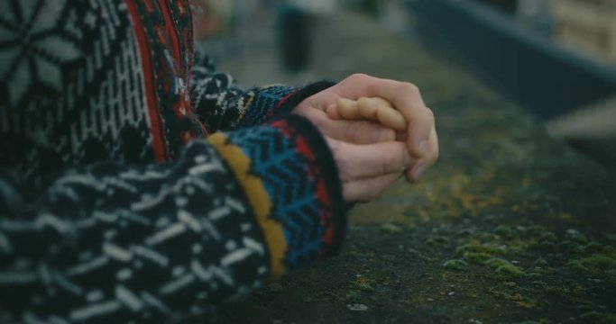 Young woman with raynaurds disease warming her hands