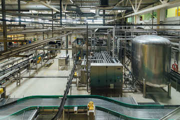 Modern brewery production line. Large vat for beer  fermentation and maturation, pipelines and...