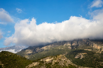 Green mountain covered by cloudy sky. Fethiye, Mugla, Turkey.