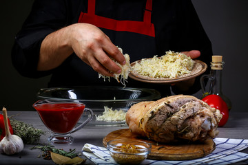 concept of german cuisine. chef hands preparing pork knuckle. Cook preparing delicious pork knuckle with the addition of beer. Bavarian cooking recipe