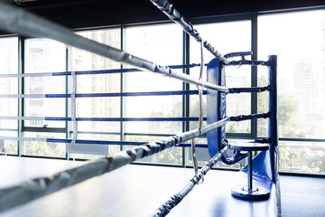 Empty ring overlooking the bright window. The concept of the upcoming competition. Boxing school...