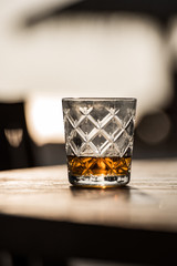 a whiskey glass on the beach 