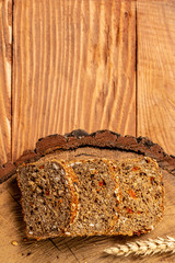 Sliced rye bread on cutting board. Whole grain rye bread with seeds of goji berry. healthy food concept. space for text. top view