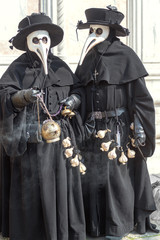 Two pest doctors with incense burner and garlic