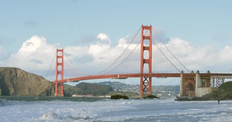 Huge waves crashing under the Golden Gate Bridge in San Francisco, seen from Baker Beach.