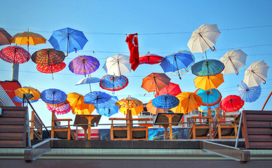 Colored Umbrellas hanging on a rooftop patio