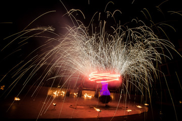 Amazing fire show dance. Fire dancers in beautiful costumes playing with flame