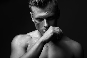 concept of creative portrait of a guy with a metal / silver carosis on the body. A strong look, a cry of strength and struggle with yourself