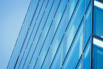 Fototapeta na wymiar Blue skyscraper out of glass, modern office building