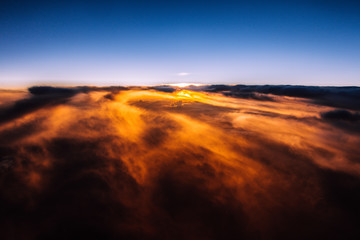 Fototapeta na wymiar Beautiful sunset above the clouds