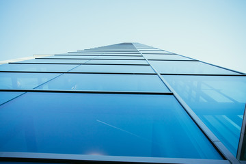 Fototapeta na wymiar Modern skyscraper out of glass and blue sky