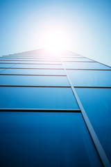 Blue skyscraper out of glass, sunbeam
