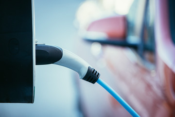 Churching an electric car with power cable supply, plugged in