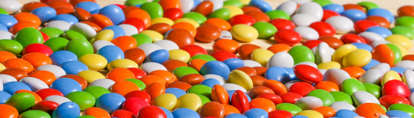 colorful chocolate candies on wooden background