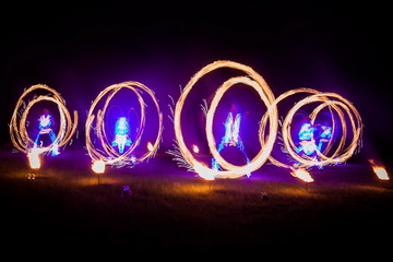 Amazing fire show dance. Fire dancers in beautiful costumes playing with flame