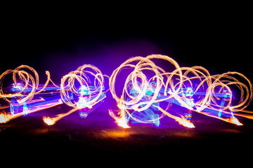 Amazing fire show dance. Fire dancers in beautiful costumes playing with flame