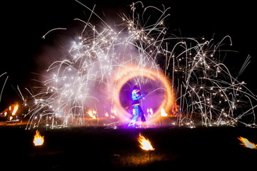 Amazing fire show dance. Fire dancers in beautiful costumes playing with colorful flames