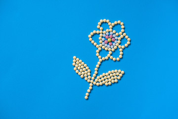 Assorted pharmaceutical medicine pills, tablets and capsules and bottle on purple background. Drugs and various narcotic substances. Copy space for text. Stock photo for design