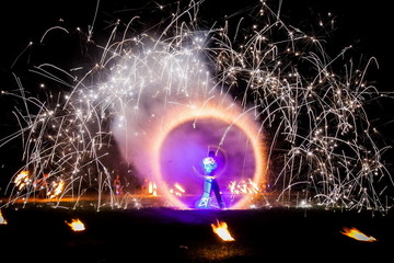 Amazing fire show dance. Fire dancers in beautiful costumes playing with flame