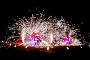 Amazing fire show dance. Fire dancers in beautiful costumes playing with flame