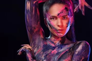 Young woman painted different colors. Inspired dance to music. Body art colorful. An amazing woman with art fashion makeup and bodyart. © Mike Orlov