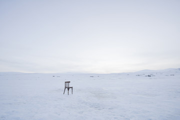 chair in the frozen lake and snow