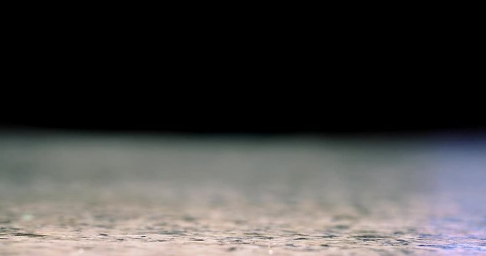 Close up of hand grabbing a mixed cocktail off of bar