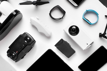 glasses and camera near the smart watch, background image of the gadgets on white surface - obrazy, fototapety, plakaty