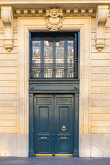 Fototapeta na wymiar Paris, beautiful wooden massive door, girder with sculptures 