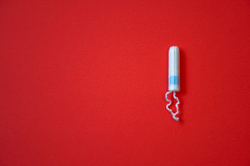 Background red on the theme of a monthly menstrual cycle. PMS and protection against it. Tampon and...