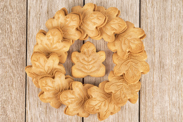 Gourmet cookies filled with maple cream on a wooden plank, directly above.