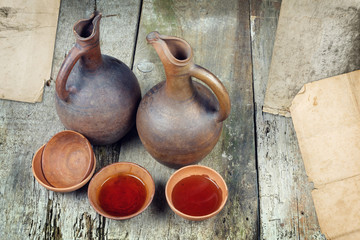 A wine jug and set of clay cups