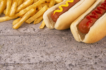 Duo of hot dogs and french fries on table. Fast food restaurant concept. Close up.