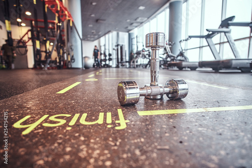 Sport, fitness, health. Dumbbells lying on the floor in the fitness center