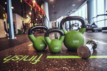 Set of weights and dumbbells on the mat in the fitness center. Sport, fitness, health.