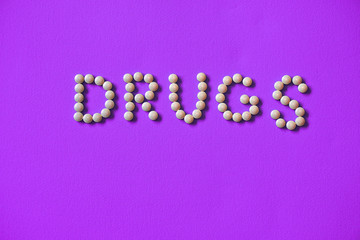 Assorted pharmaceutical medicine pills, tablets and capsules background.lined inscription from the tablets of narcotic substances. Text of the drug warning. Stock photo for design