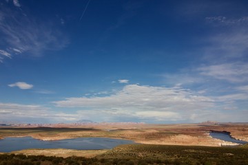 Lake in the Desert in Utah, USA. Blue sky with gigantic clouds over the canyon background.