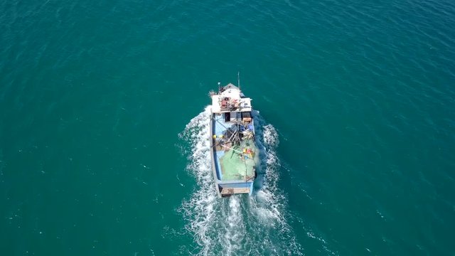Small fishing boat at sea - Aerial footage.