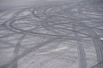 Abstract of Black tire wheels caused by Drift car on the road. Braking at a pedestrian crossing and a road with markings. Stock photo for design