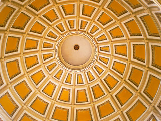 Concentric rings and yellow painted panels inside the dome of the Colorado capitol building