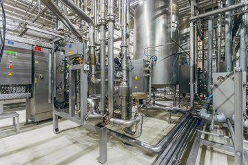 Modern brewery interior. Filtration vats, pipeline, valves and other equipment of beer production line