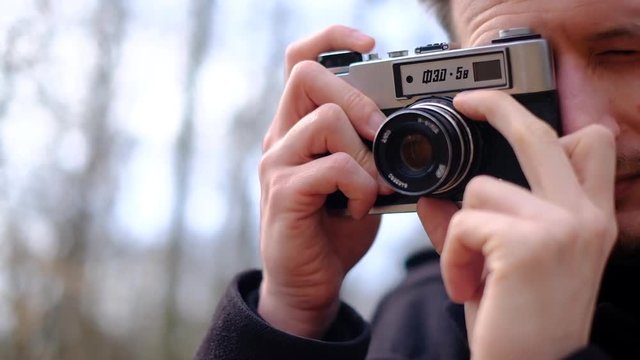professional photographer taking pictures of nature with old analog camera